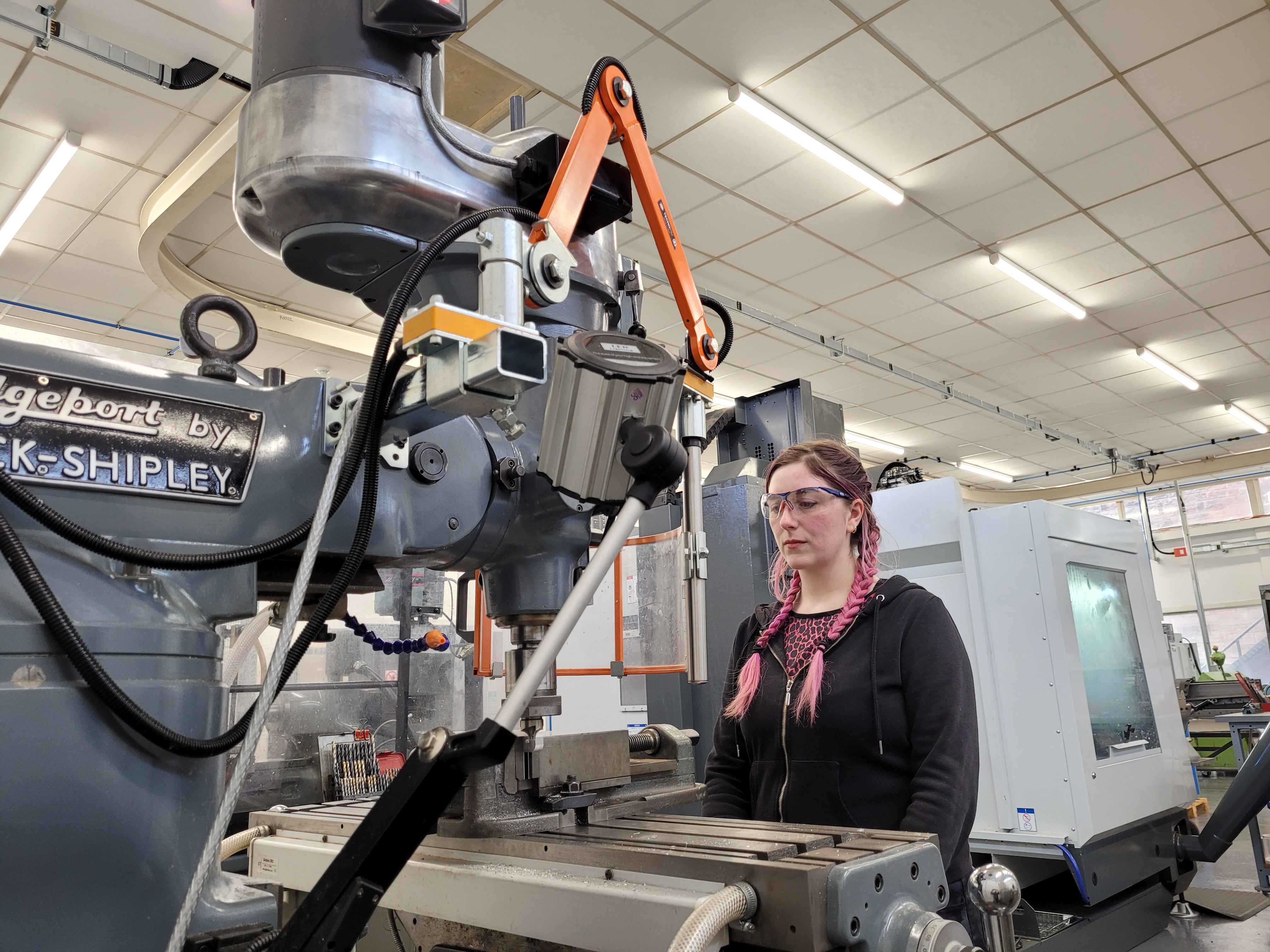 An apprentice working on a machine in the workshop on site at UK ATC.